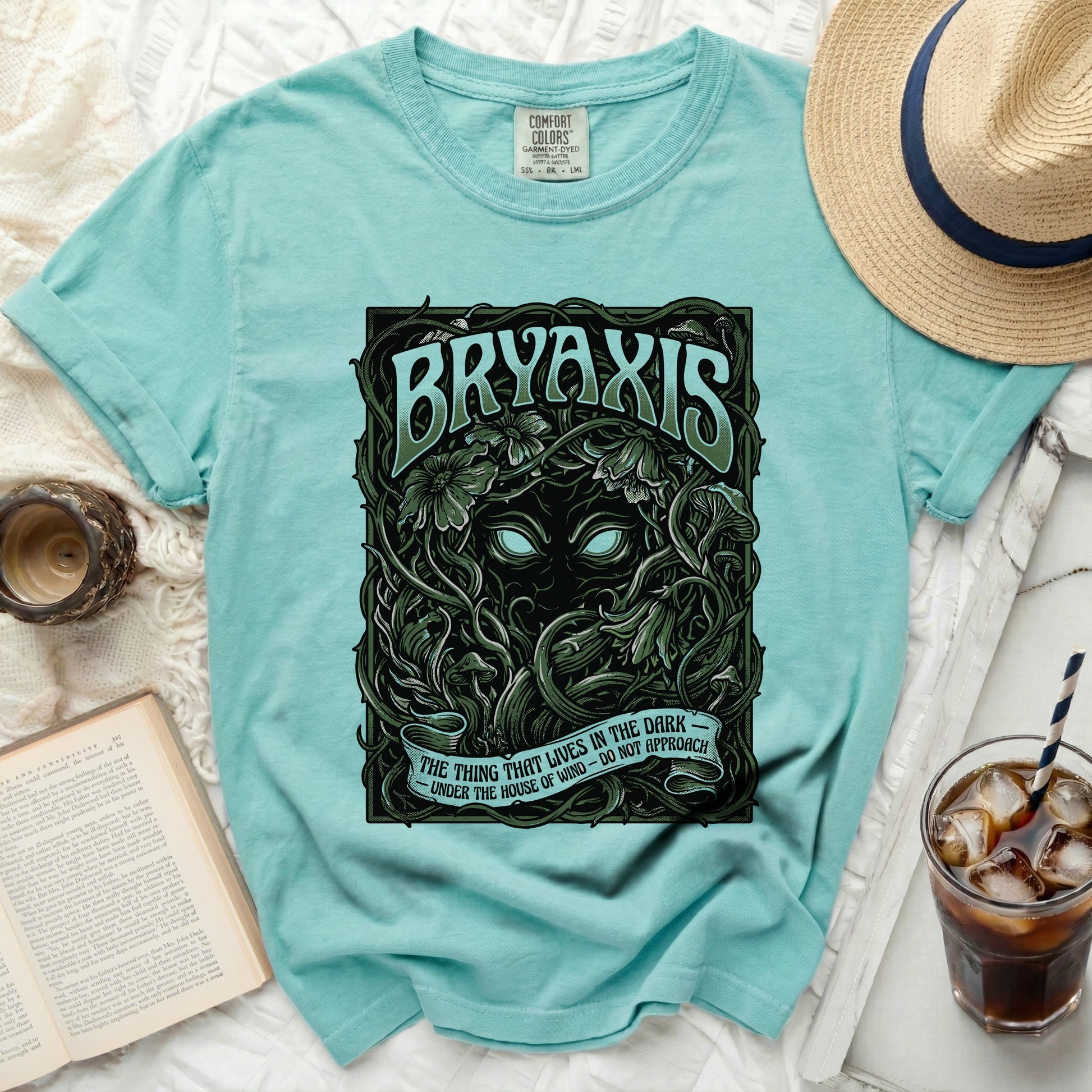 Teal t-shirt with "BRYAXIS" and "The thing that lives in the dark" text.