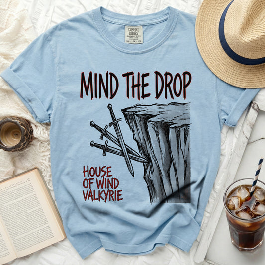 Light blue t-shirt with "MIND THE DROP" and "HOUSE OF WIND VALKYRIE" text.