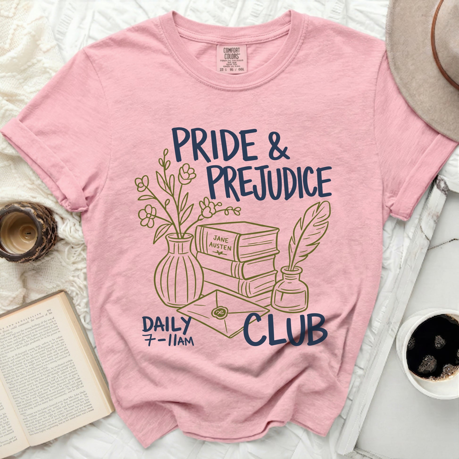 Pink t-shirt with "Pride & Prejudice Club" and book illustrations.