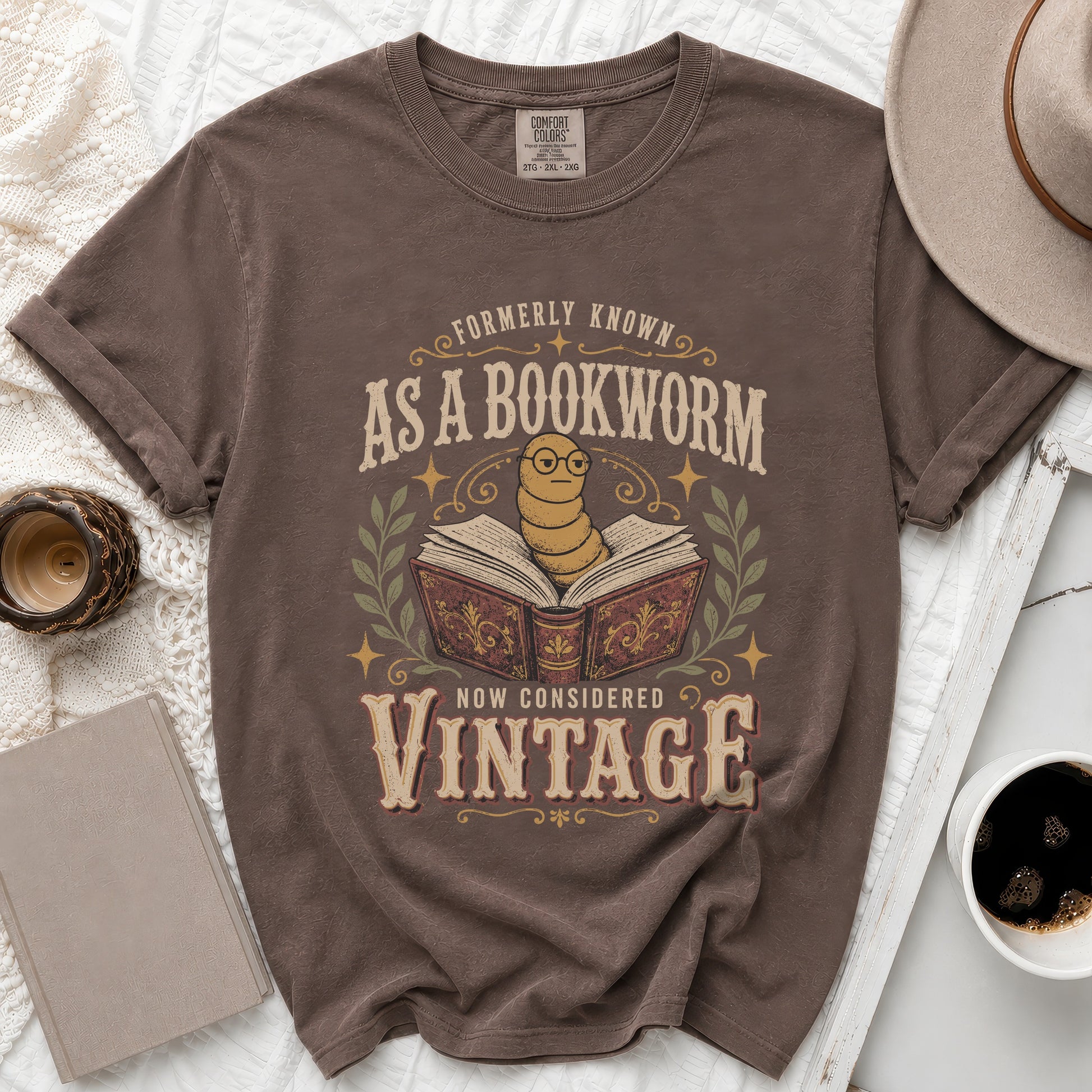Brown t-shirt with text "Formerly Known As A Bookworm Now Considered Vintage" and a worm graphic.