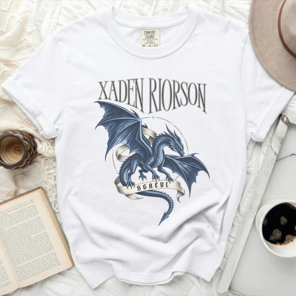 White t-shirt with blue dragon graphic and text "XADEN RIORSON" and "SGAEYL".
