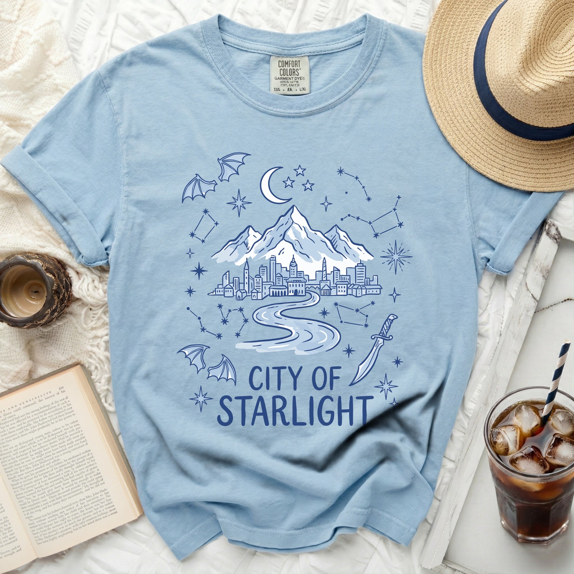 Light blue t-shirt with a "City of Starlight" graphic and celestial elements.
