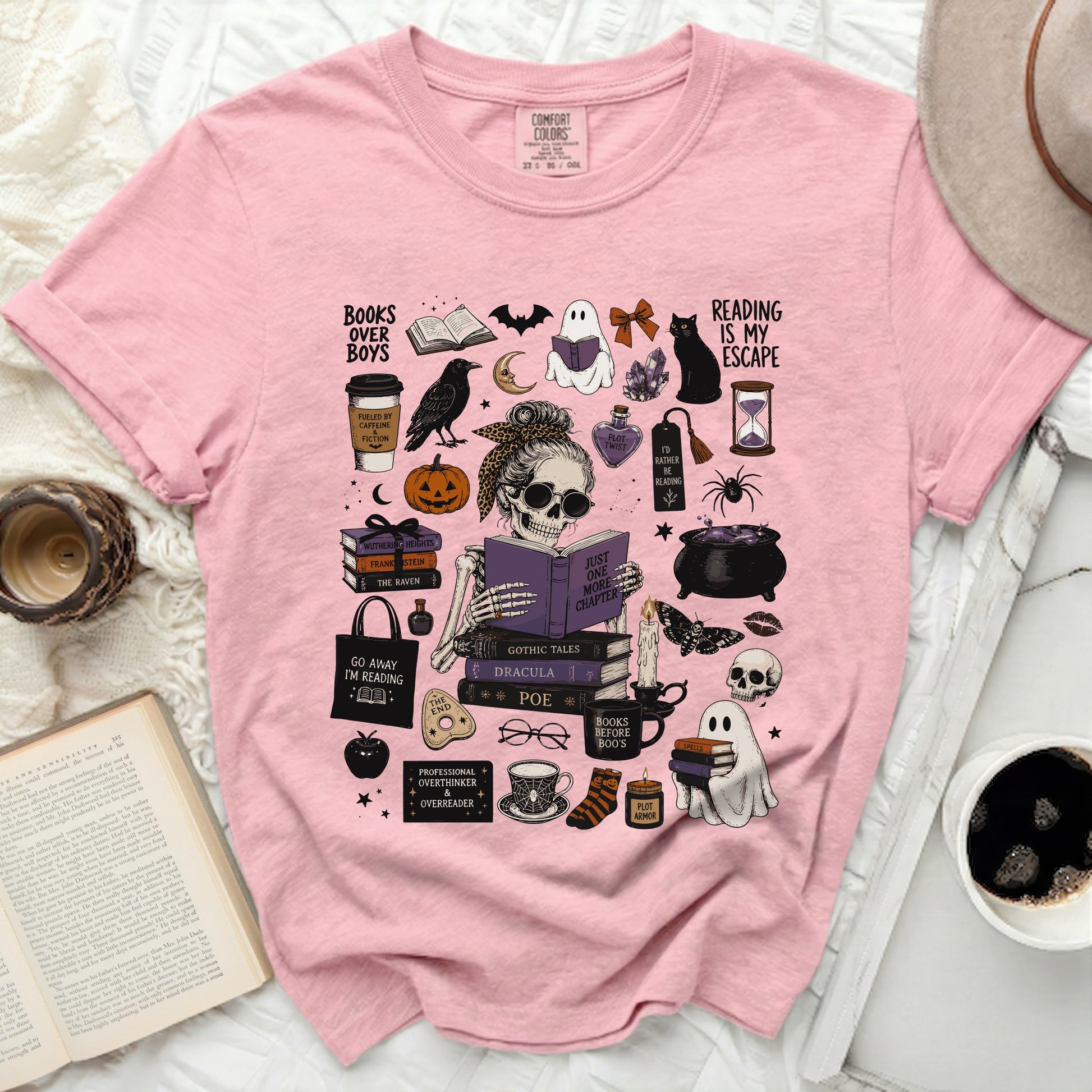 Pink t-shirt with Halloween-themed reading illustrations including a skeleton ghost and books.