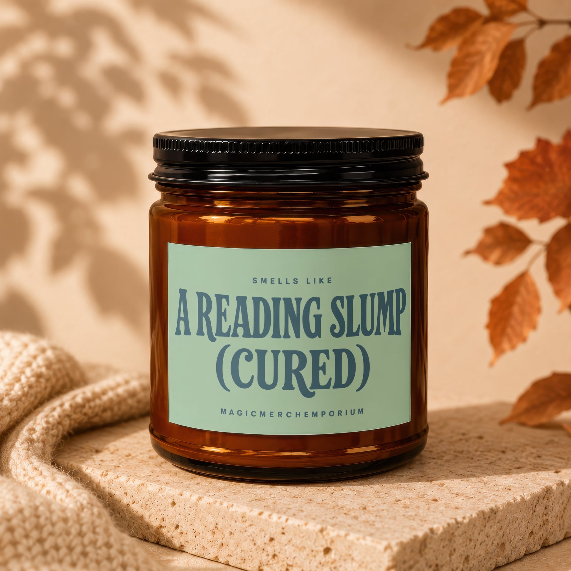 Amber candle with text "Smells Like A Reading Slump (Cured) - MagicMerchEmporium".
