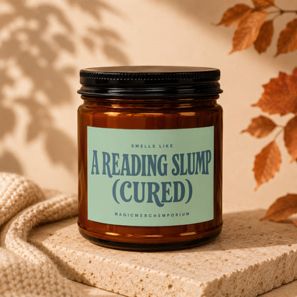 Amber candle with text "Smells Like A Reading Slump (Cured) - MagicMerchEmporium".