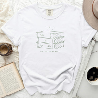 White t-shirt with minimalist stacked books and text "JUST ONE MORE PAGE."