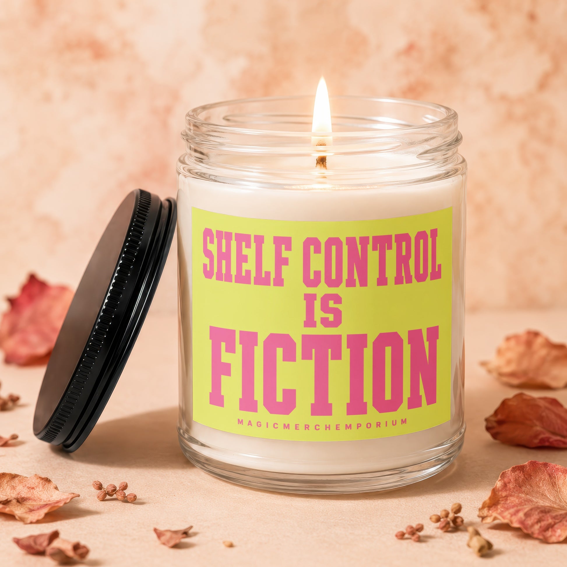 Candle with pink text "Shelf Control Is Fiction" on a yellow label.