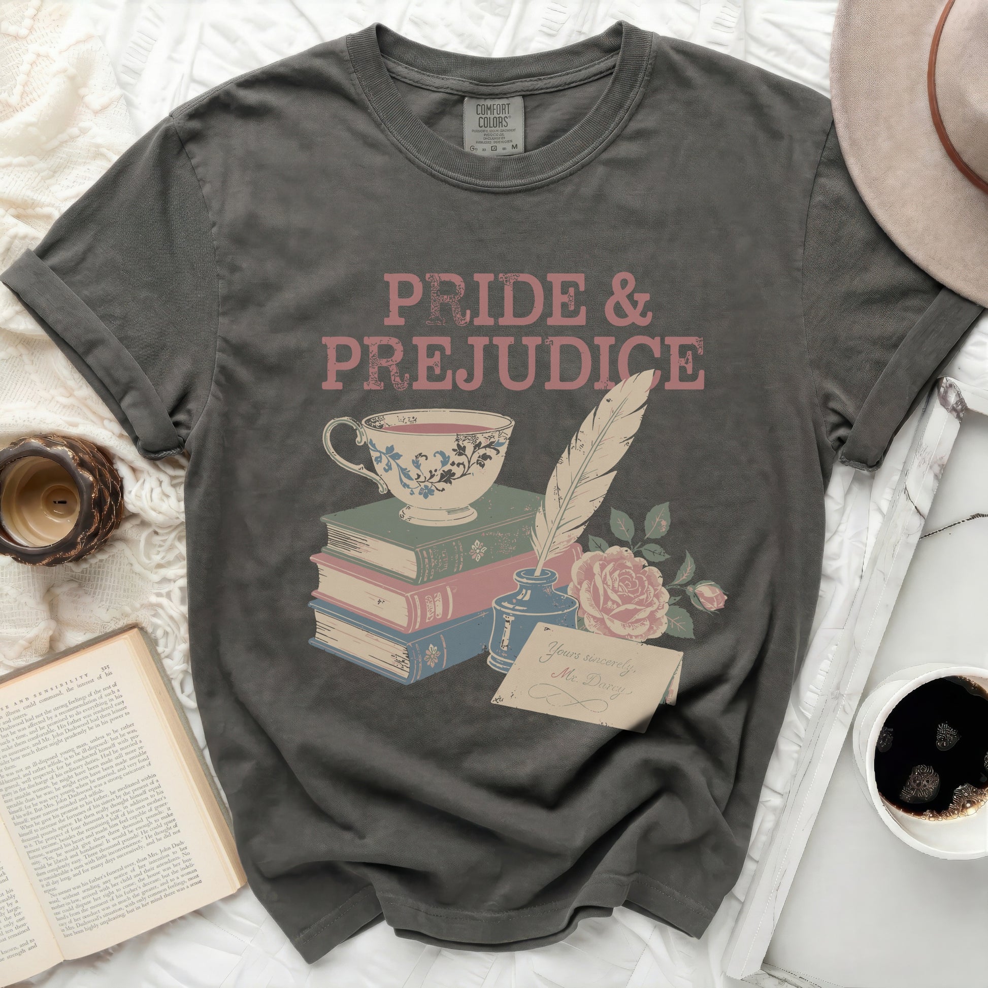 Grey t-shirt with "Pride & Prejudice" text and literary icons.