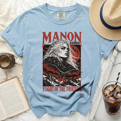 Light blue t-shirt with "Manon Blackbeak Flight of the Thirteen" graphic.