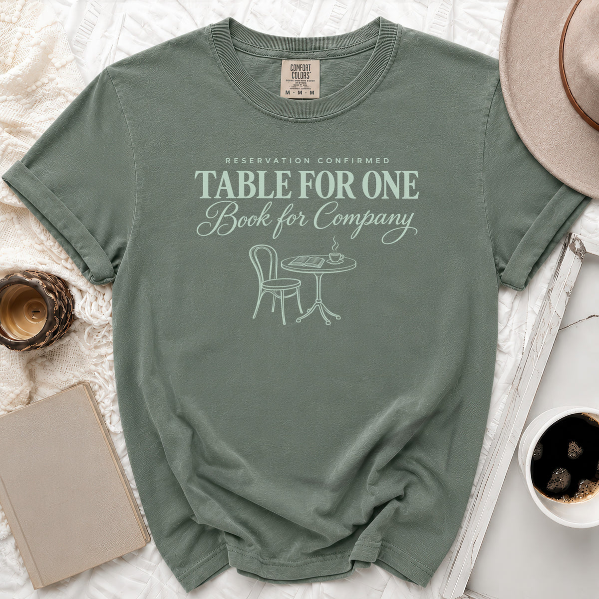 Green t-shirt with text "RESERVATION CONFIRMED TABLE FOR ONE Book for Company".