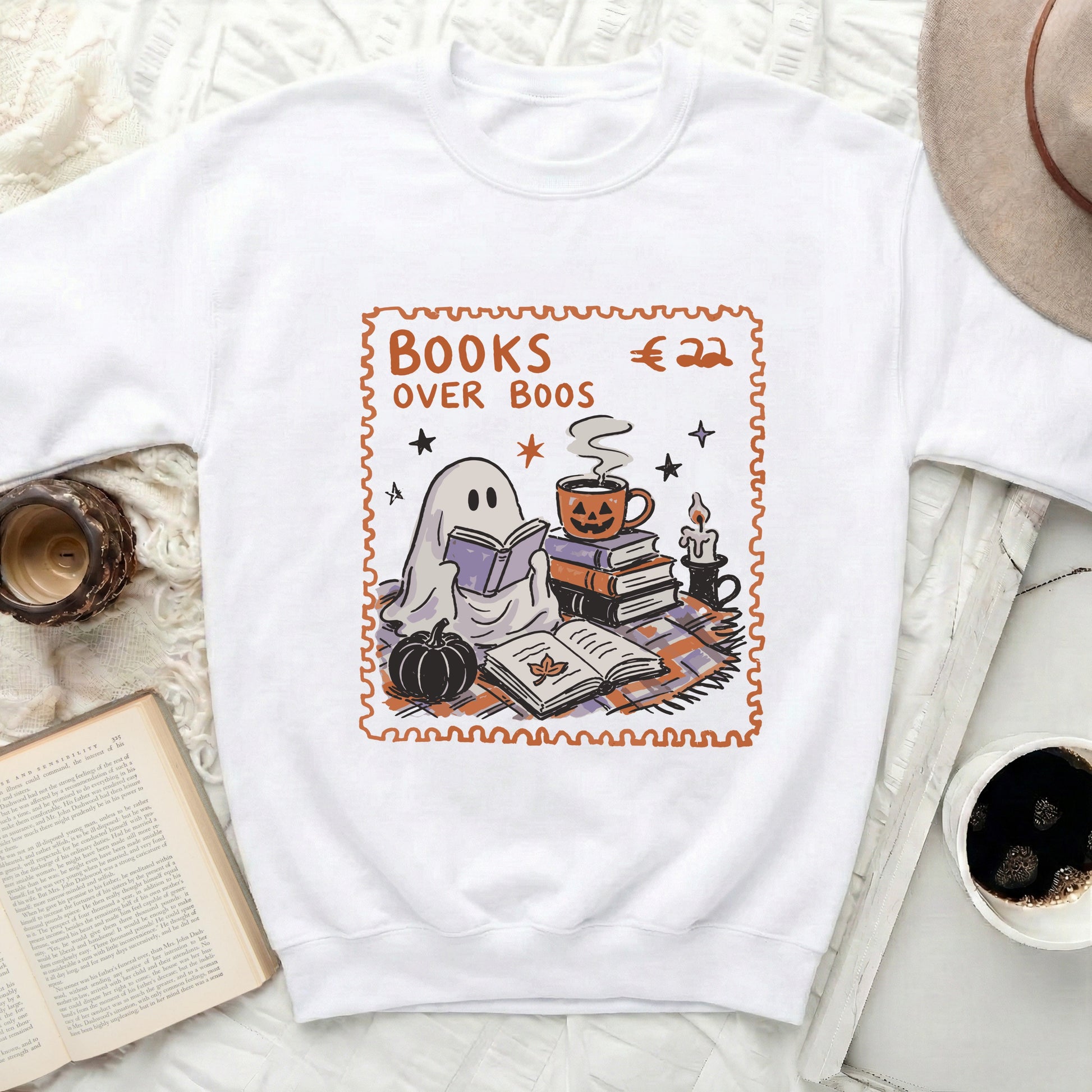 White sweatshirt with Halloween-themed graphic reading "Books Over Boos" around a ghost.