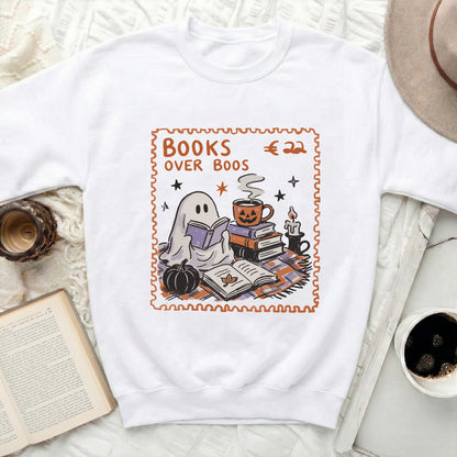 White sweatshirt with Halloween-themed graphic reading "Books Over Boos" around a ghost.