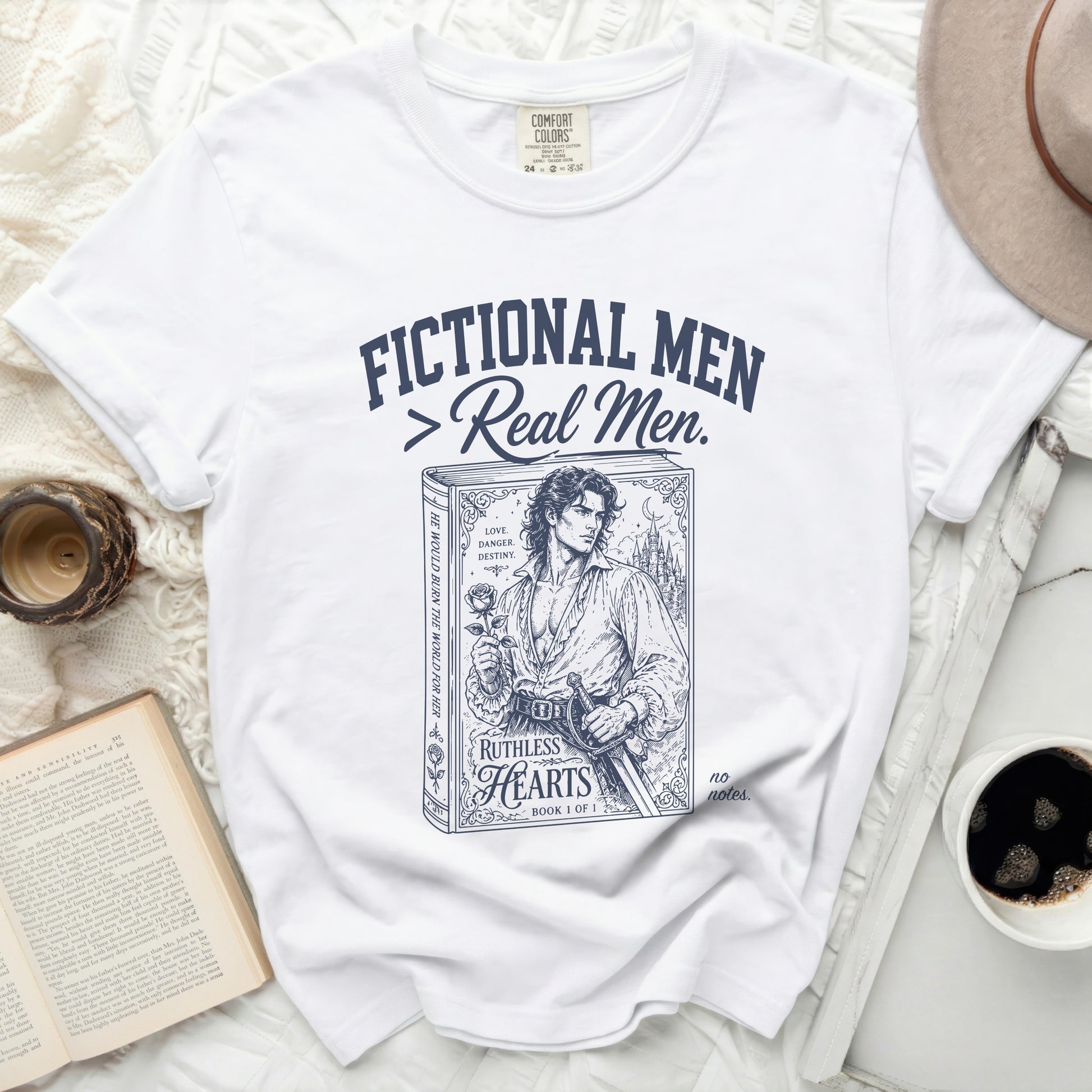 White t-shirt with "Fictional Men > Real Men." and a book cover illustration.