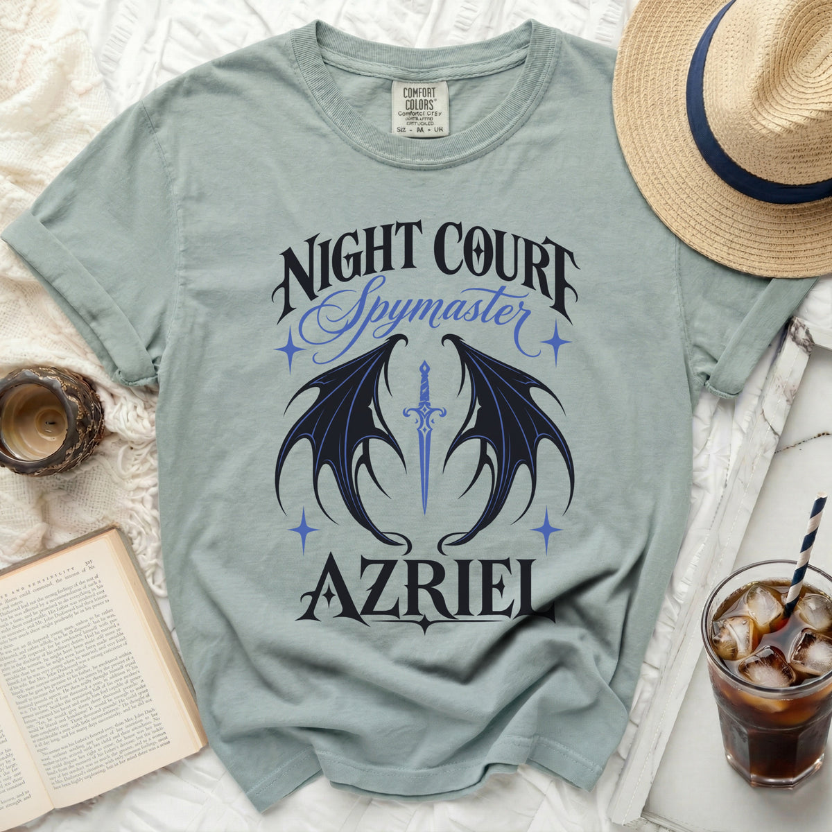 Light blue t-shirt with "NIGHT COURT Spymaster AZRIEL" and bat wings.