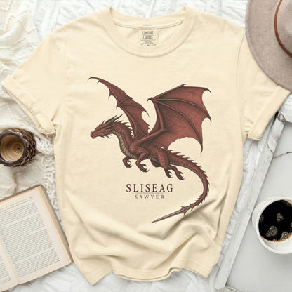 Cream t-shirt with a red dragon graphic and text SLISEAG SAWYER.