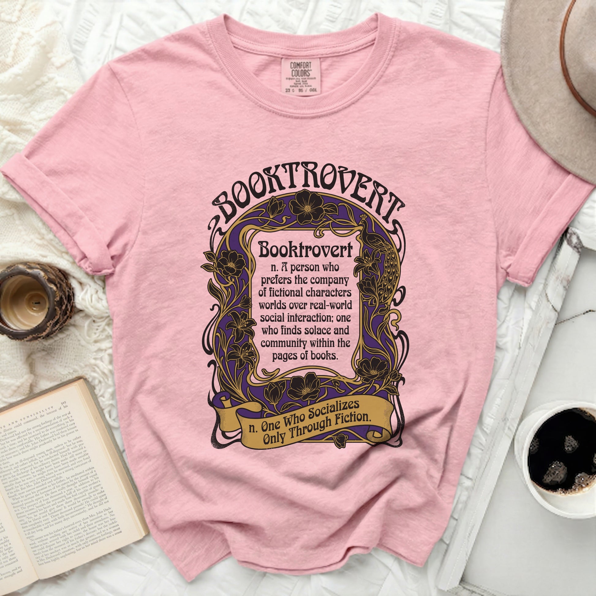Pink t-shirt with "Booktrovert" definition in purple and gold text.