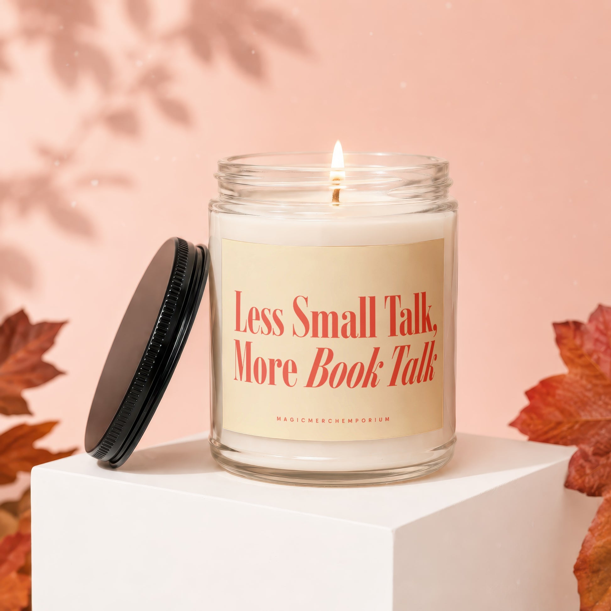 Glass candle with label "Less Small Talk, More Book Talk" on a pedestal.
