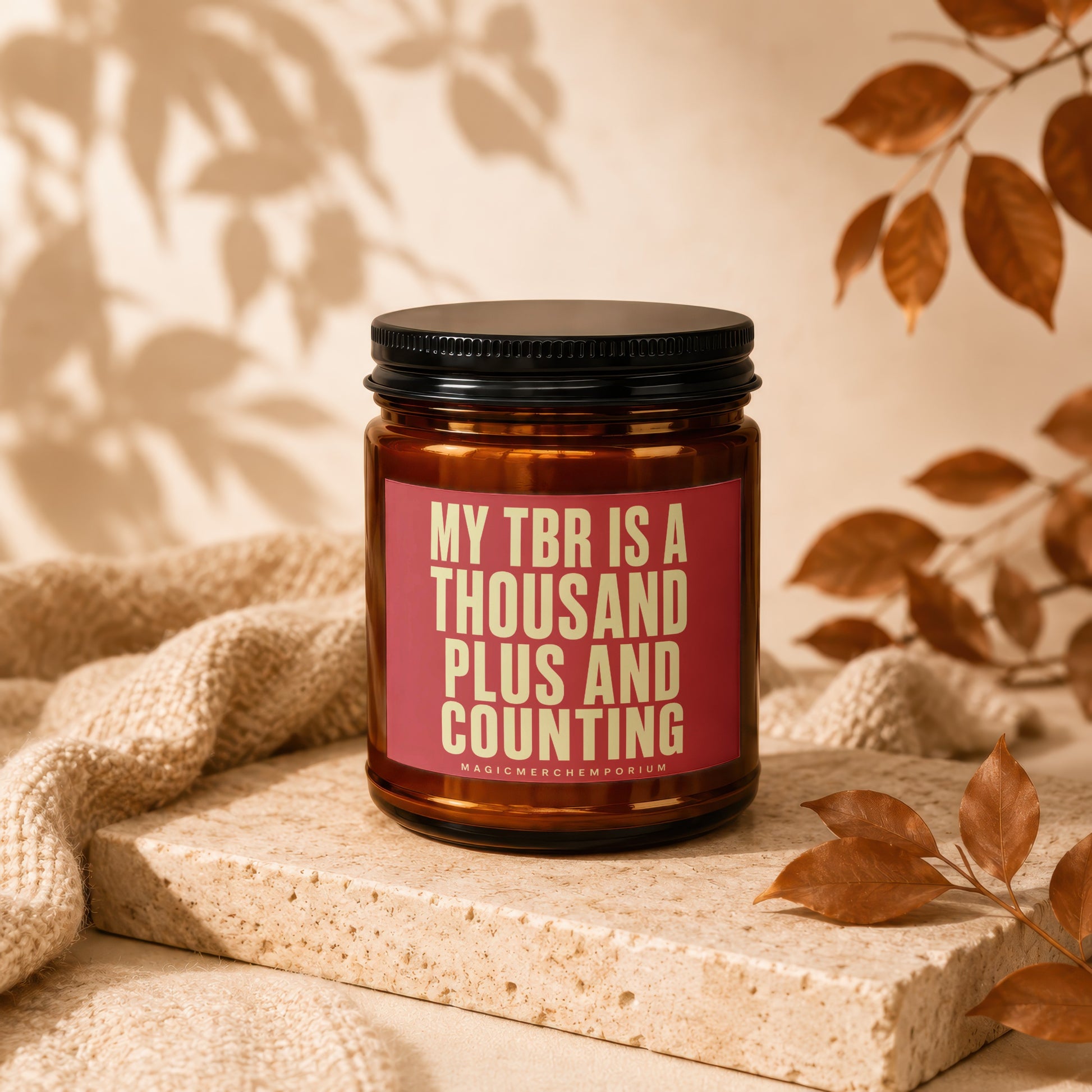 Amber jar candle with "MY TBR IS A THOUSAND PLUS AND COUNTING" text.