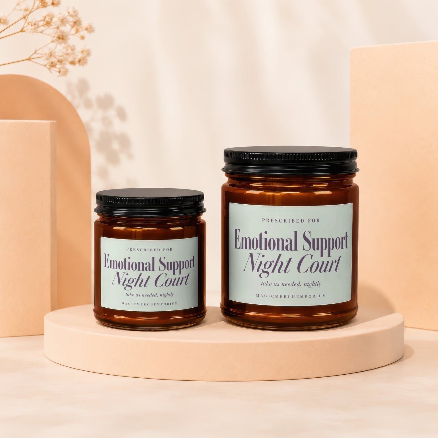 Two brown glass jars with "Emotional Support Night Court" labels on a light-colored stage.