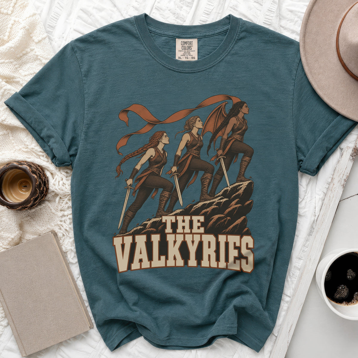 Teal t-shirt with "The Valkyries" graphic of three women with swords.