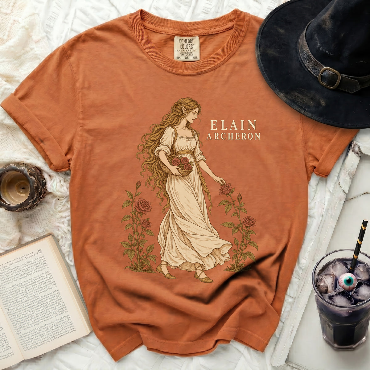 Orange t-shirt with "Elain Archeron" and a drawing of a woman picking roses.