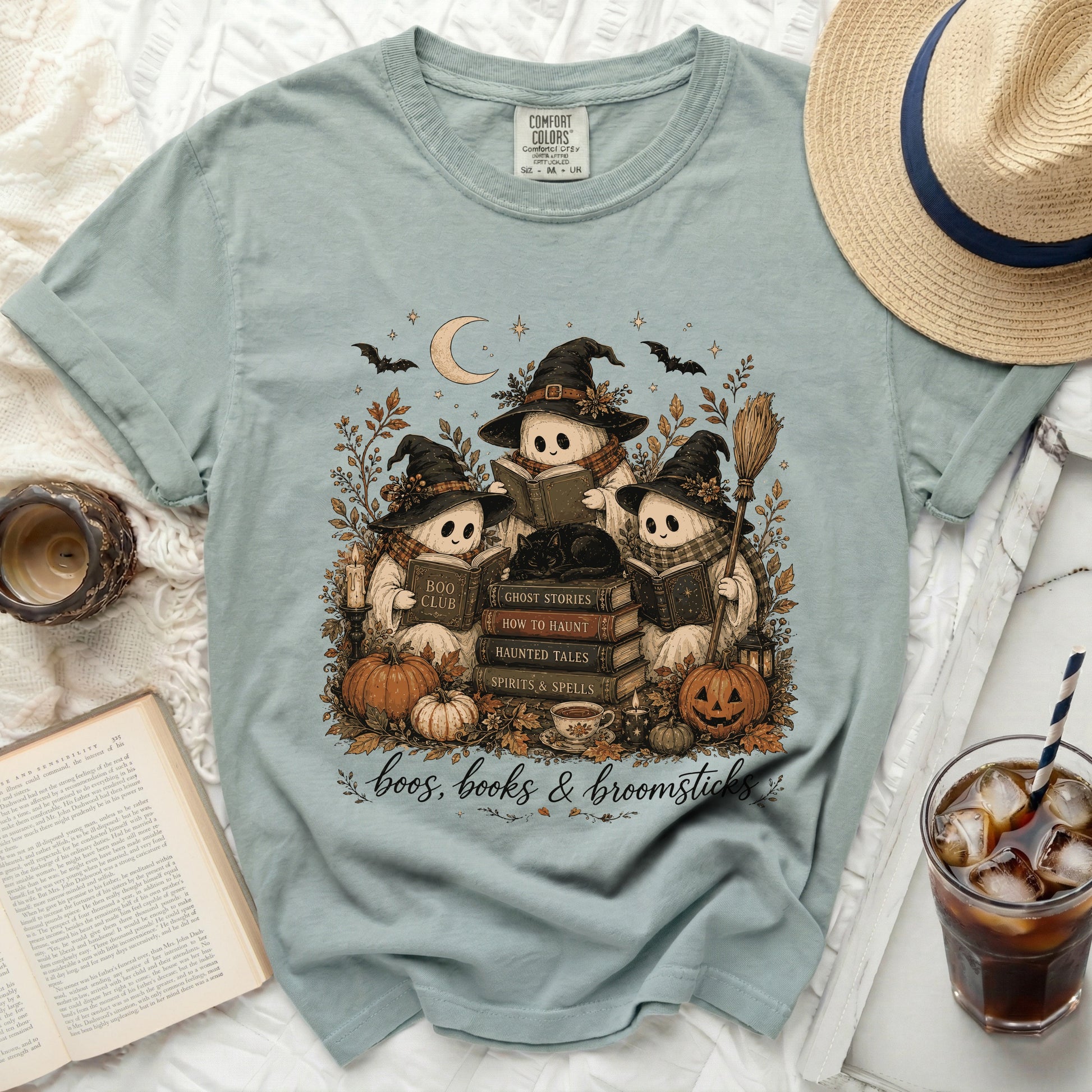 Three cartoon ghosts in Halloween hats read books amidst pumpkins and leaves.