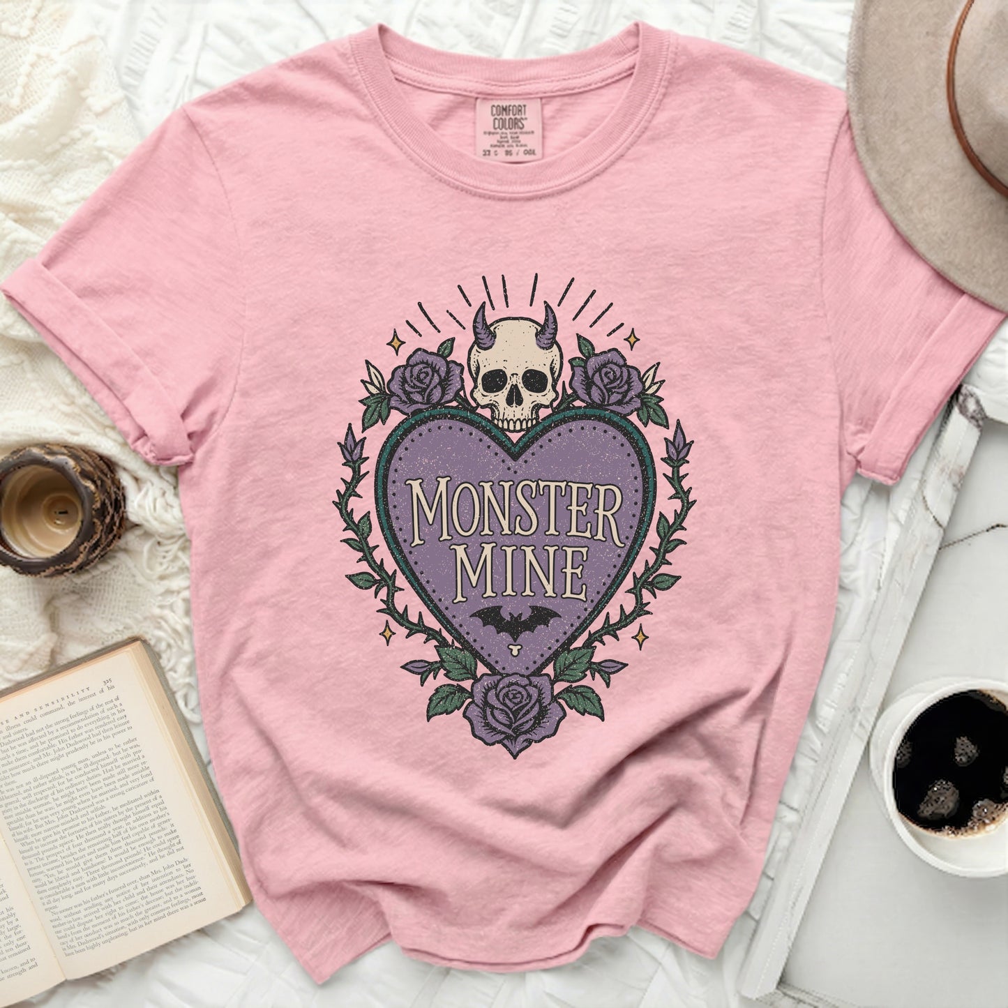 Pink t-shirt with "MONSTER MINE" text and heart-shaped skull graphic.