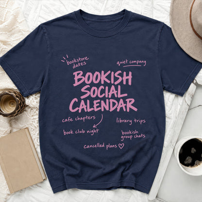 Navy t-shirt with pink text "BOOKISH SOCIAL CALENDAR" and related phrases.
