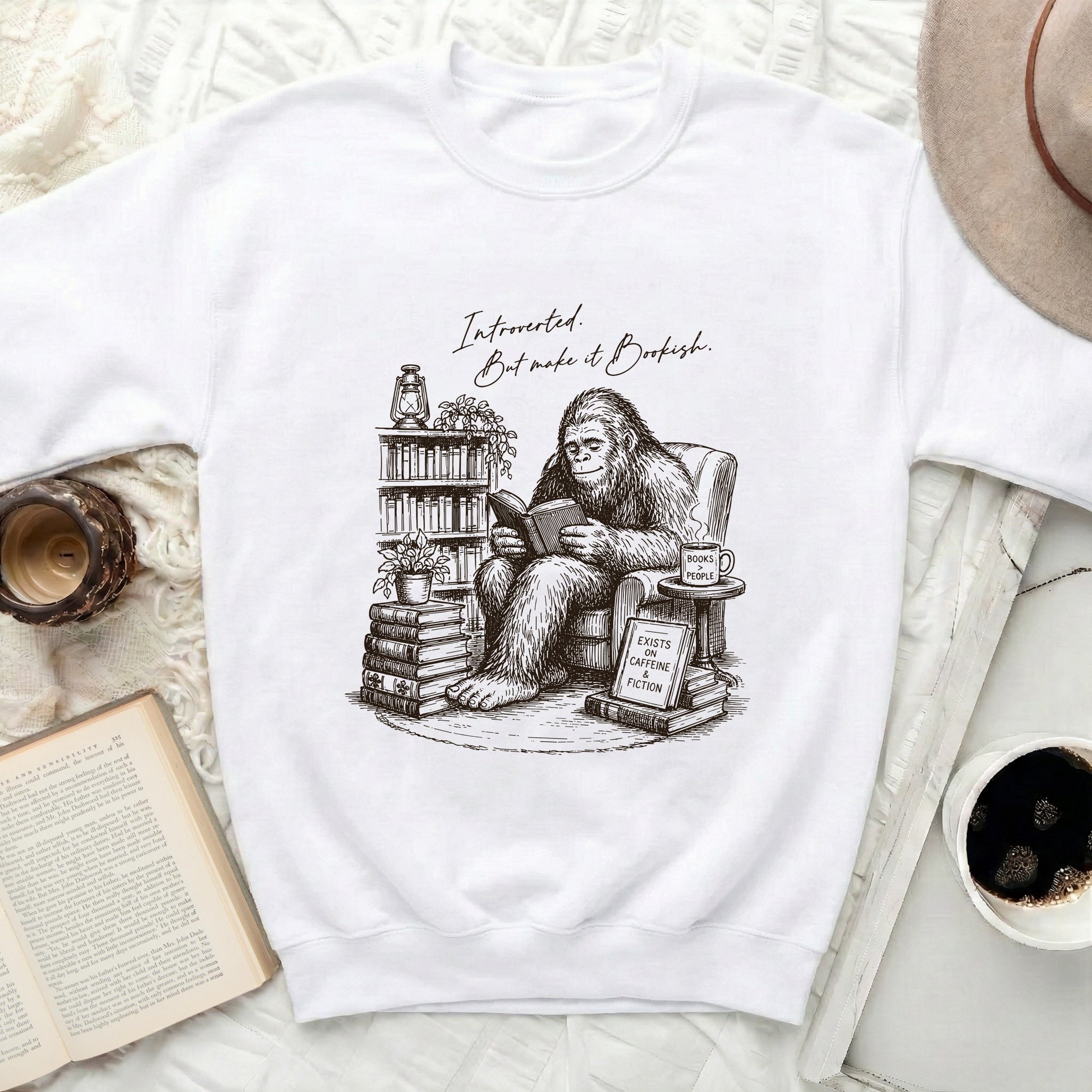 Bigfoot wearing glasses, reading a book, with text "Introverted. But make it Bookish."