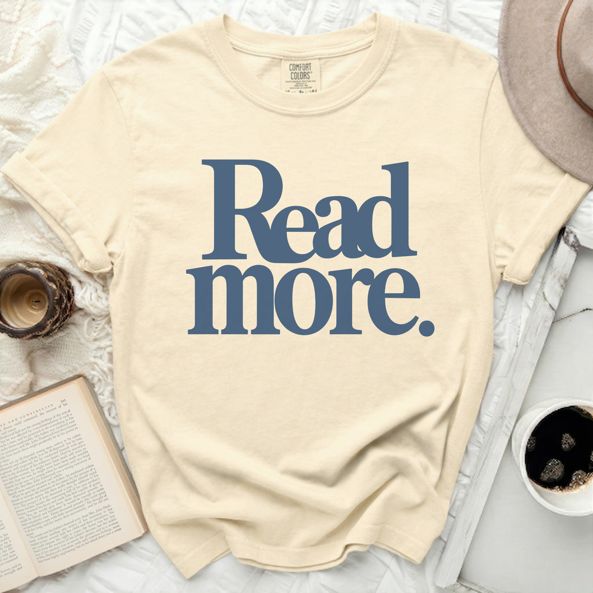 Cream t-shirt with "Read more." text in blue.