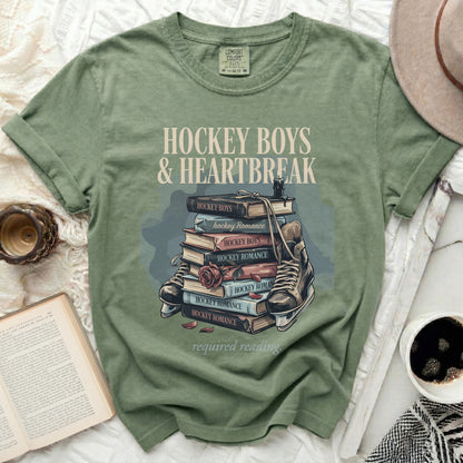 T-shirt with "Hockey Boys & Heartbreak" text and stacked books.