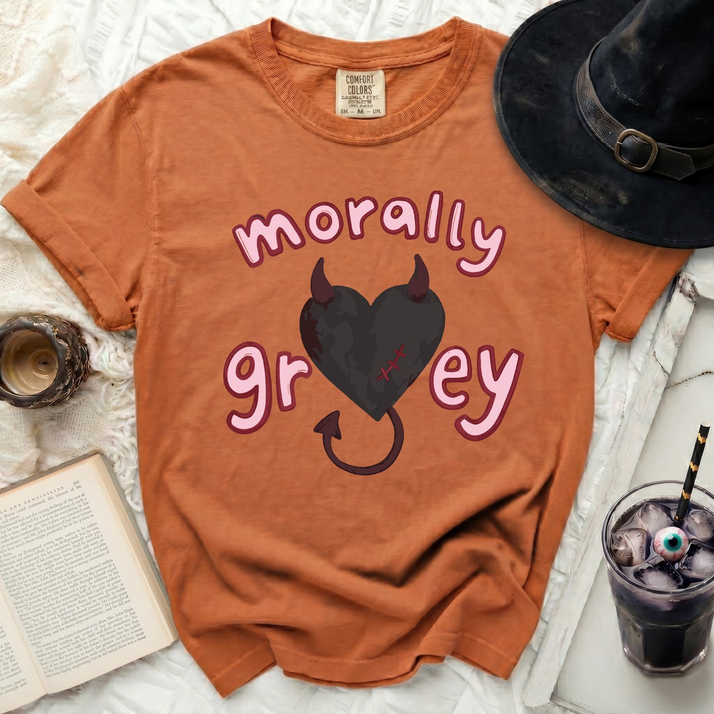 Orange t-shirt with "morally grey" text and a black heart with horns.