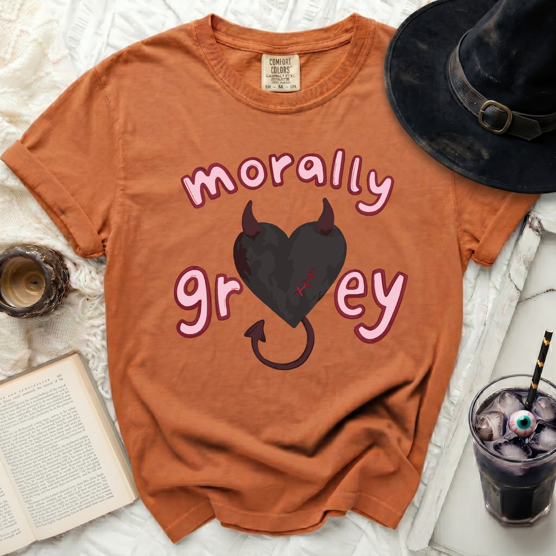 Orange t-shirt with "morally grey" text and a black heart with horns.
