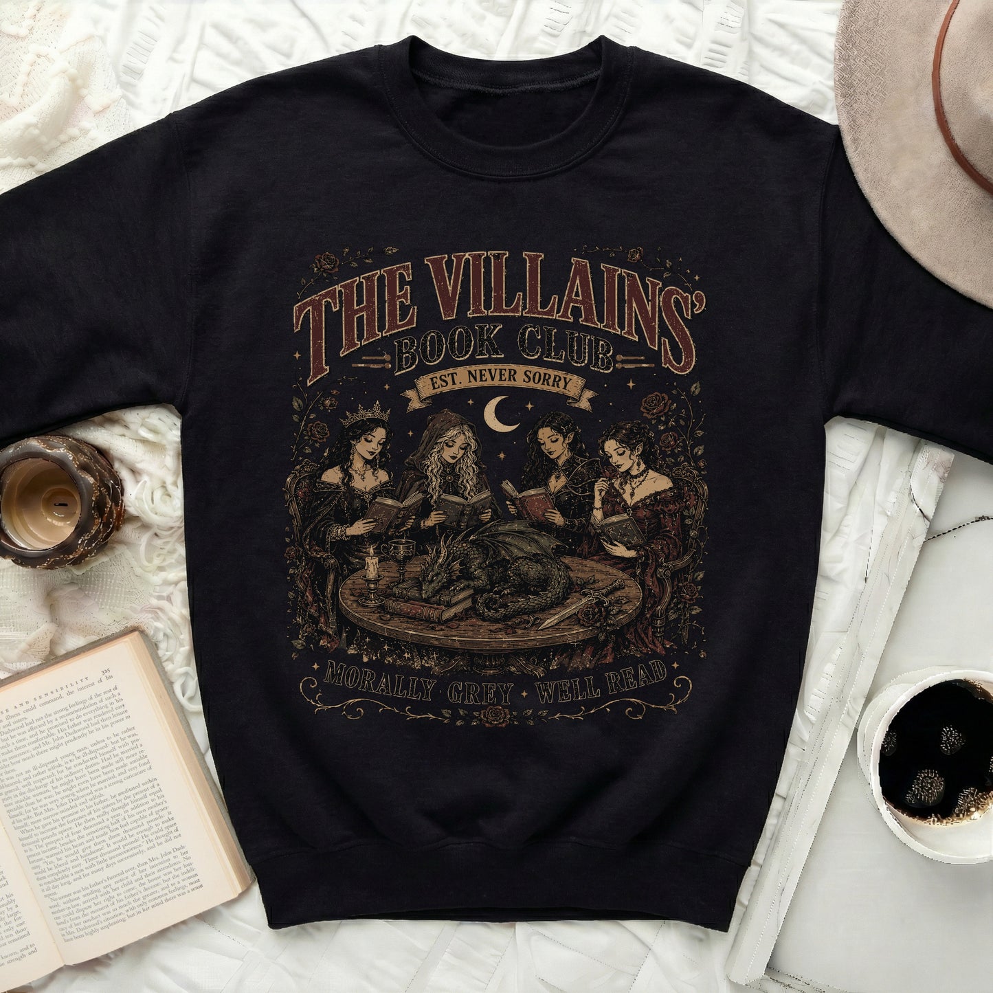 Black sweatshirt with "The Villains Book Club Est. Never Sorry Morally Grey Well Read" graphic.