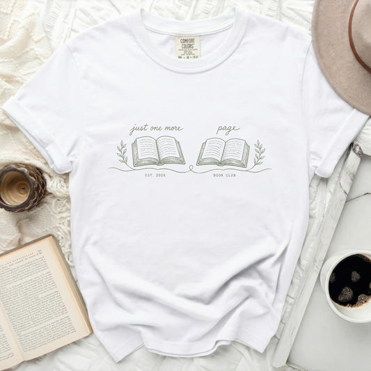 White t-shirt with "just one more page" and "BOOK CLUB EST. 2026" graphics.