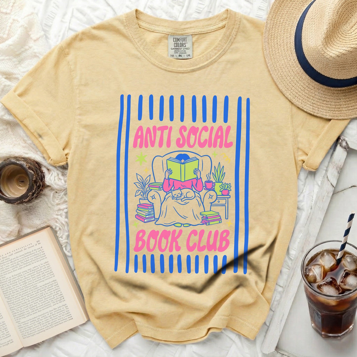 Yellow t-shirt with "Anti Social Book Club" text and a girl reading.