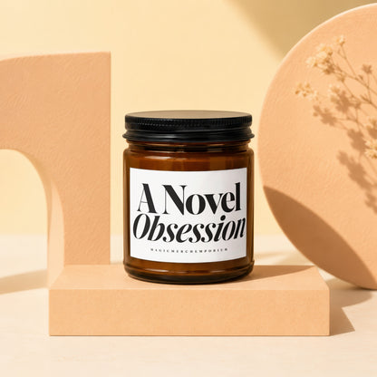 Amber jar candle labeled "A Novel Obsession" by Magic Merch Emporium.