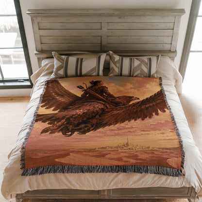 a bed with a large blanket that depicts a person riding a winged creature, possibly a dragon or a mythical bird. The blanket is spread over the bed, covering the entire surface.