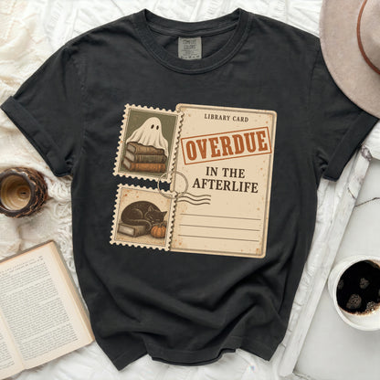 Black t-shirt with a library card graphic featuring a ghost, cat, and "OVERDUE IN THE AFTERLIFE" text.