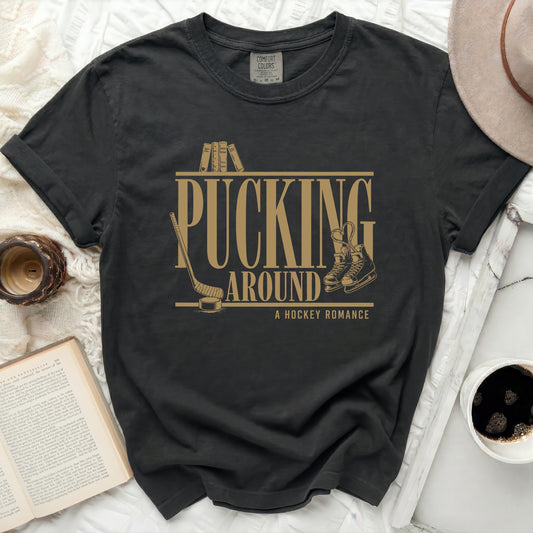 Black t-shirt with "Pucking Around A Hockey Romance" text and ice skates.