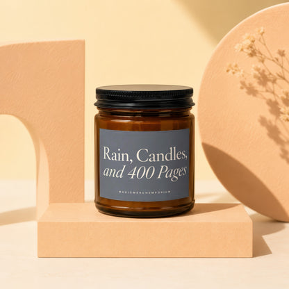 Amber jar candle with black lid featuring text "Rain, Candles, and 400 Pages".
