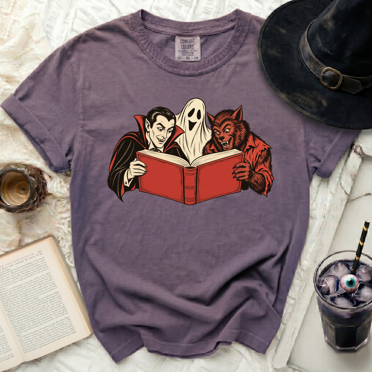 Vampire, ghost, and werewolf reading a red book together.