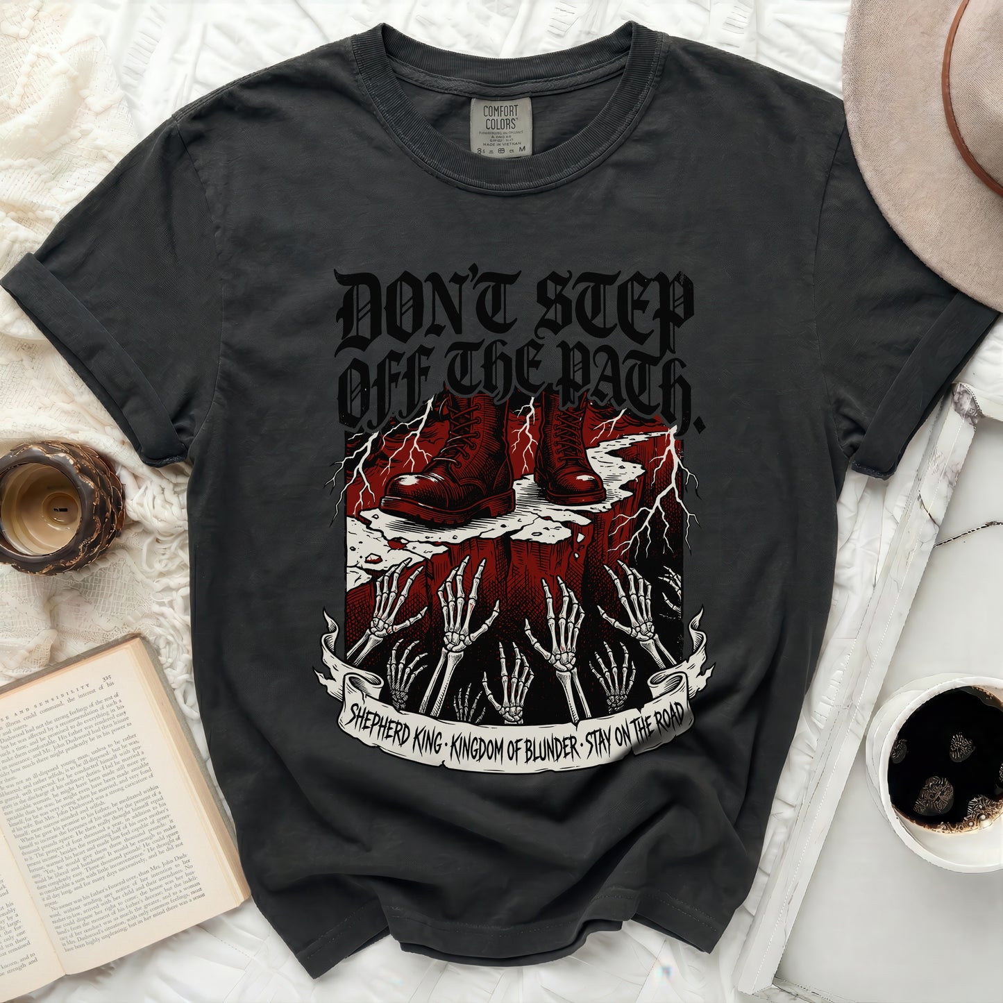 Dark t-shirt with skeleton hands, boots, and text "Don't Step Off The Path".