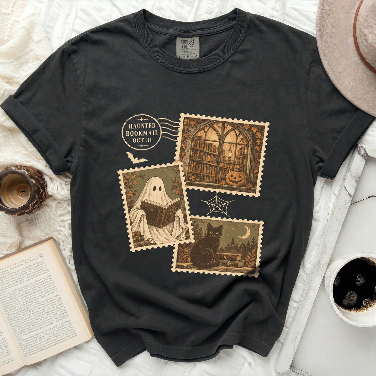 Black t-shirt with "Haunted Bookmail Oct 31" and postage stamp graphics.