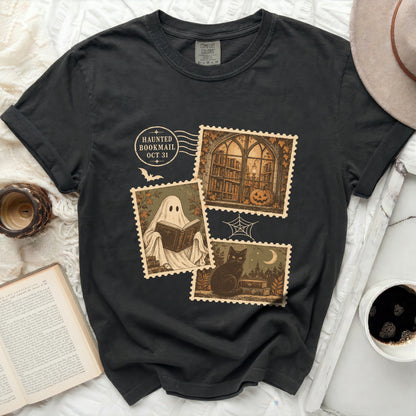 Black t-shirt with "Haunted Bookmail Oct 31" and postage stamp graphics.