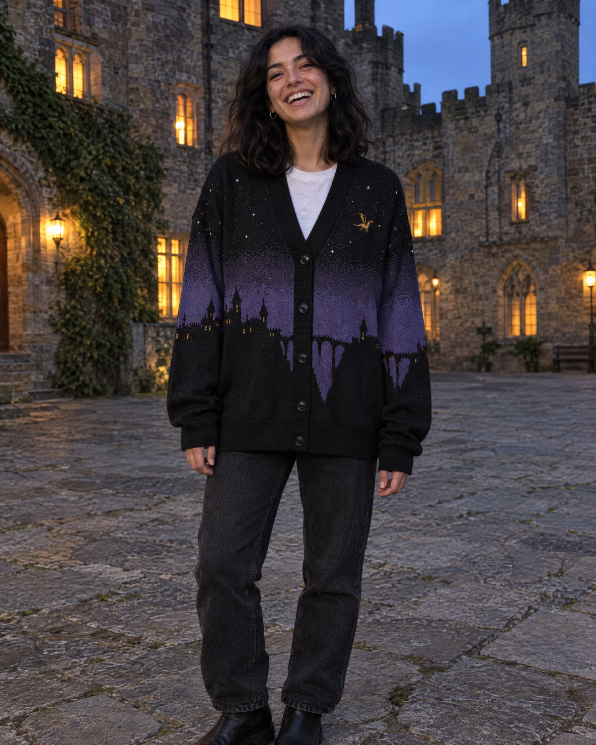 Fly or Die Basgiath Night Knitted Cardigan in a castle courtyard at blue hour