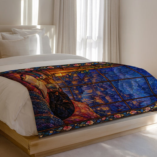 The Reader's Window Stained Glass Velveteen Plush Blanket on a bed