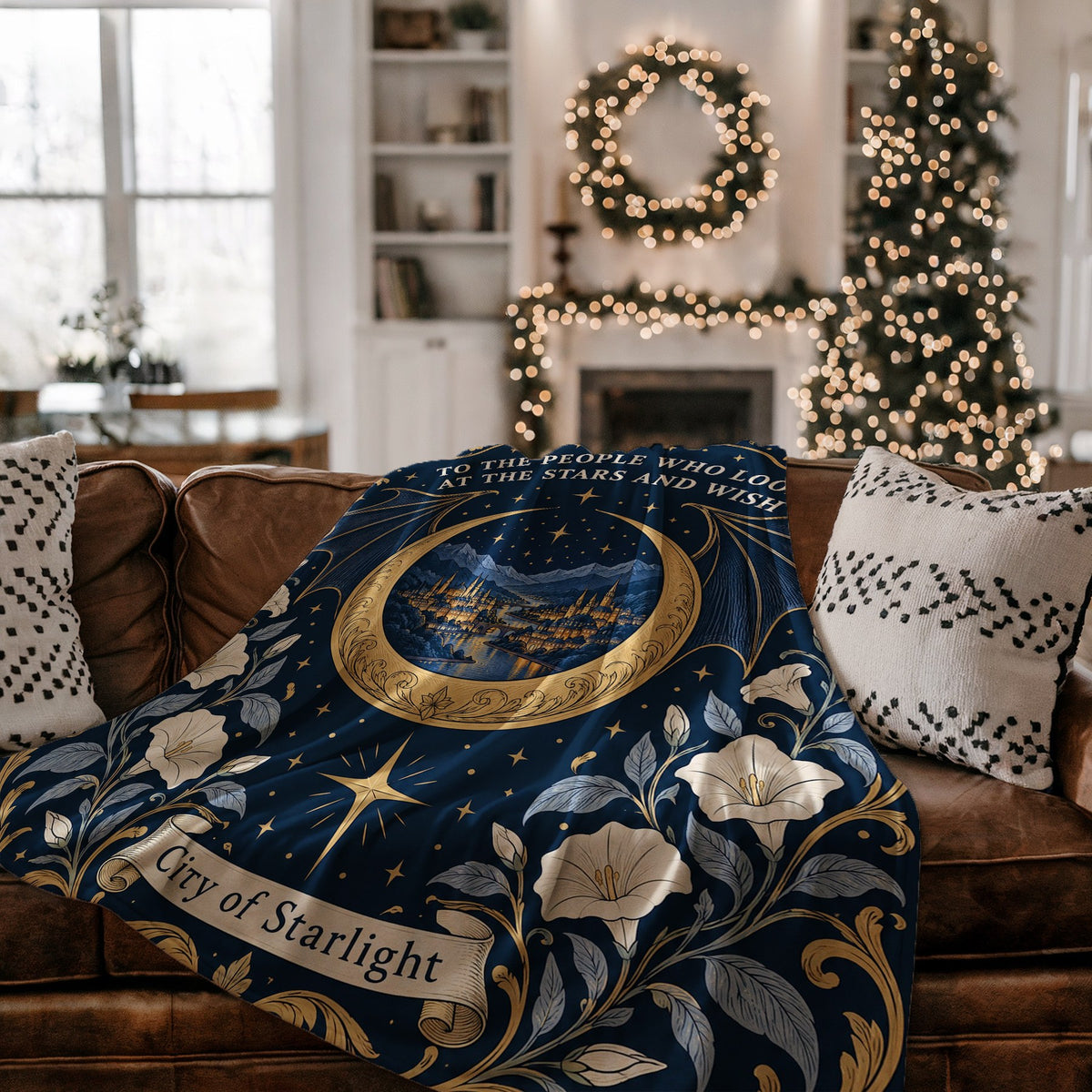Velaris City of Starlight Crest Velveteen Plush Blanket on a couch