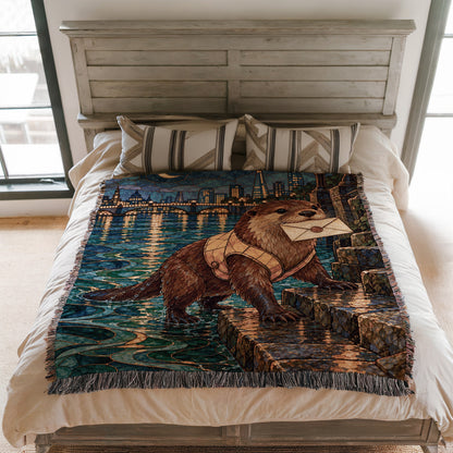 Otter Woven Throw Blanket on a bed
