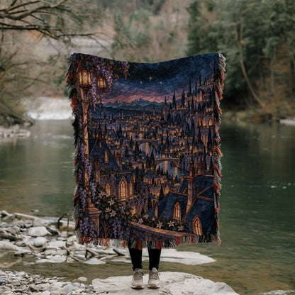 Velaris Rooftop Woven Throw Blanket held up outdoors by a river